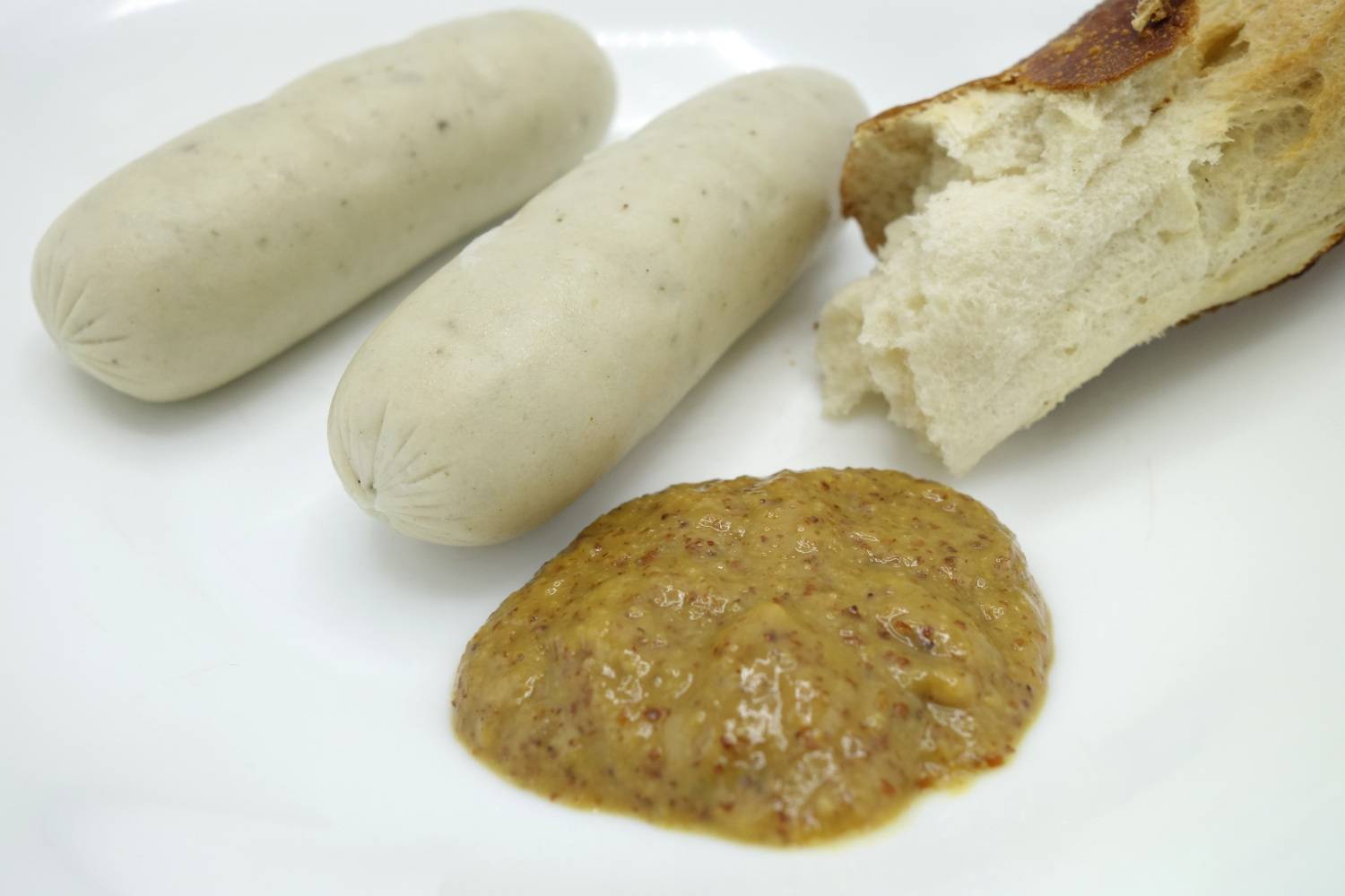 Vegane Weißwurst mit Senf und Laugenstange.